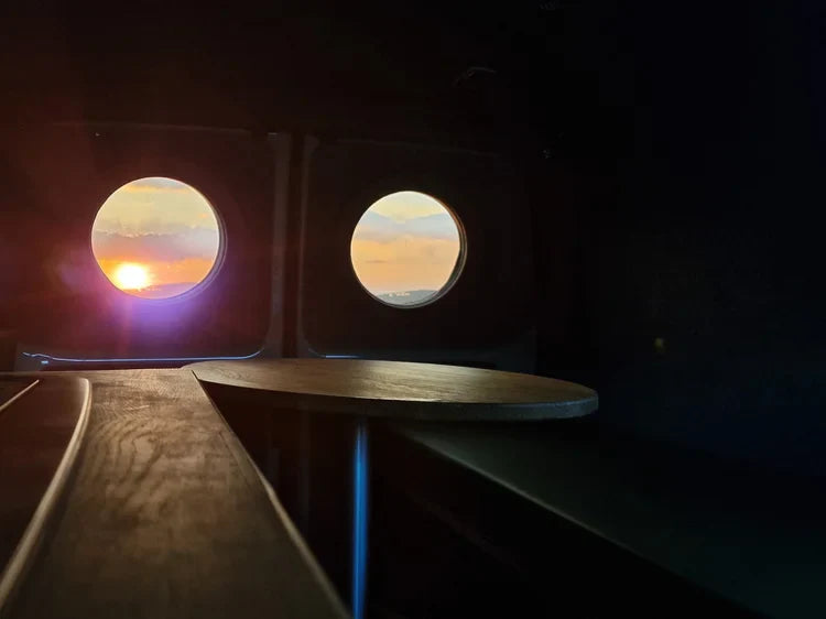 Lucille round wooden table with metal legs, glass top, orange sunset design