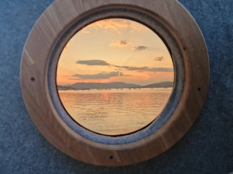 Lucille wooden porthole frame with ocean sunset view, Scottish outdoor access