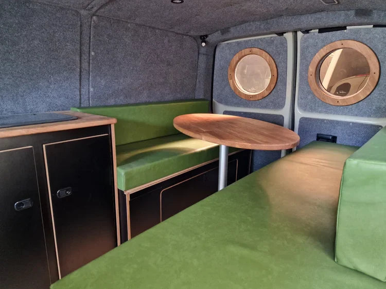 Lucille green leatherette booth with circular cutouts and wooden tabletop